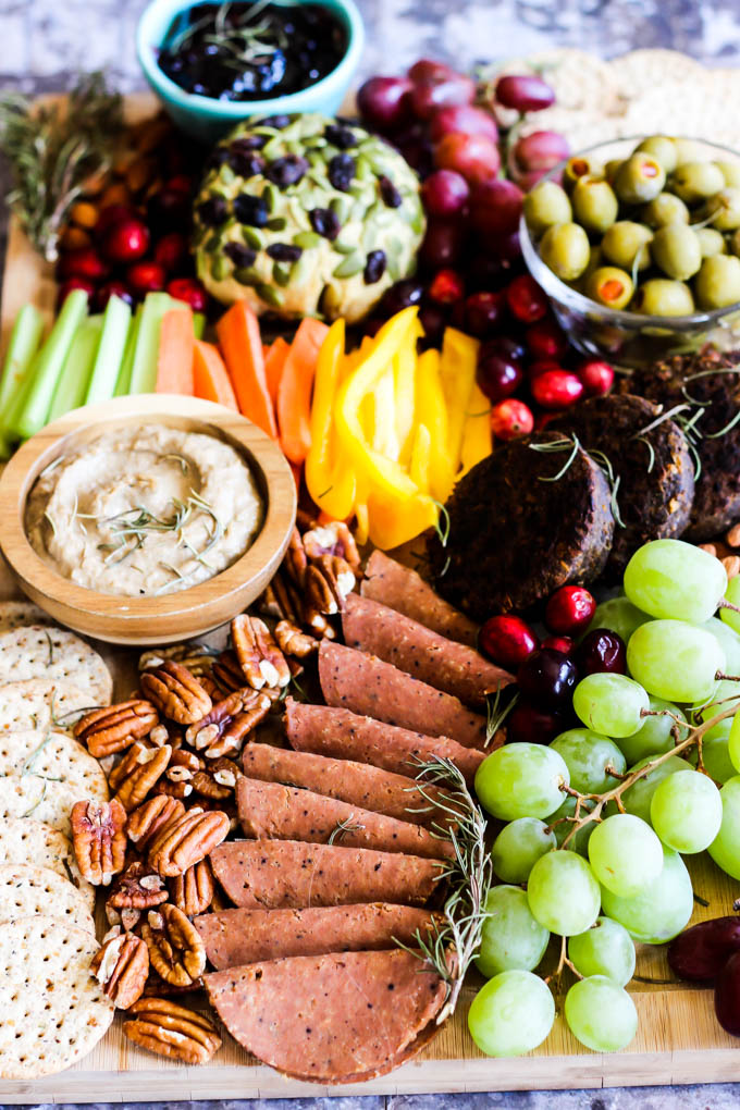 Serve this epic Vegan Charcuterie Board at your next party as a fun appetizer! Loaded with veggie meats, dairy-free cheese, fruit and vegetables.