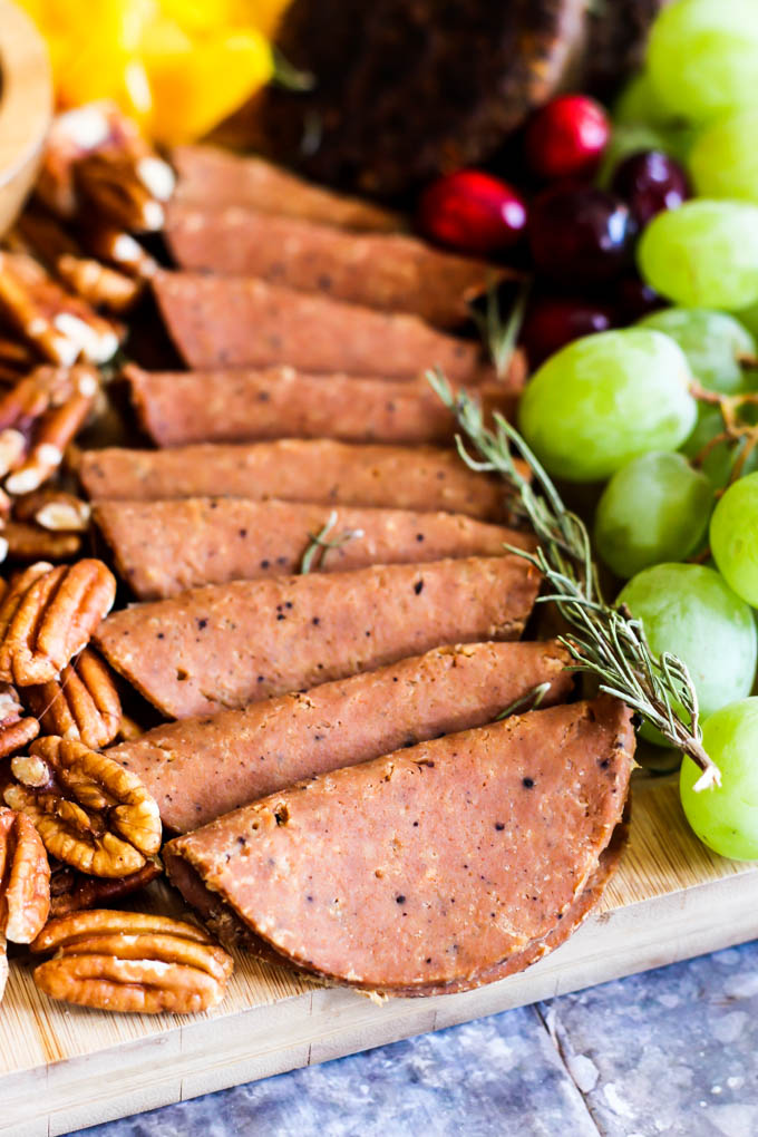 Serve this epic Vegan Charcuterie Board at your next party as a fun appetizer! Loaded with veggie meats, dairy-free cheese, fruit and vegetables.