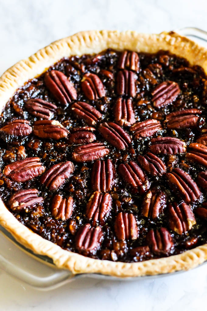 A slice of this Vegan Pecan Pie is all you need this holiday season! The sweet, gooey pecan filling tops a flaky crust that is irresistible. A must-have!