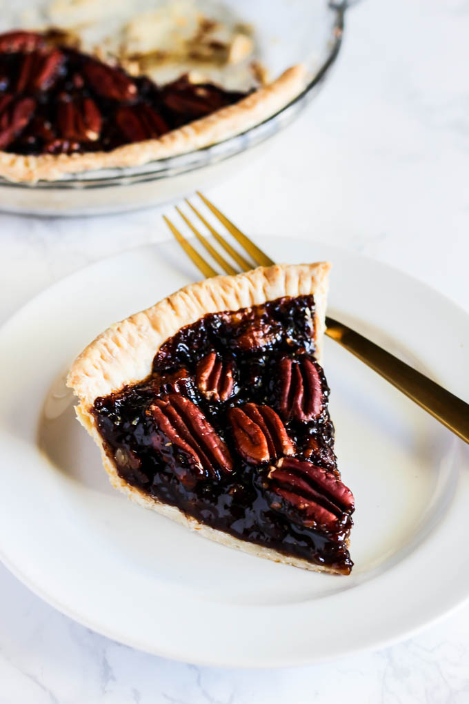 A slice of this Vegan Pecan Pie is all you need this holiday season! The sweet, gooey pecan filling tops a flaky crust that is irresistible. A must-have!