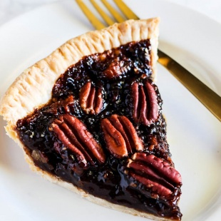 A slice of this Vegan Pecan Pie is all you need this holiday season! The sweet, gooey pecan filling tops a flaky crust that is irresistible. A must-have!