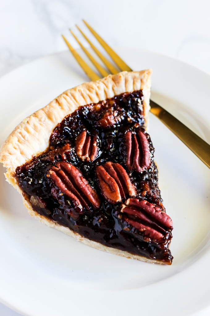 A slice of this Vegan Pecan Pie is all you need this holiday season! The sweet, gooey pecan filling tops a flaky crust that is irresistible. A must-have!