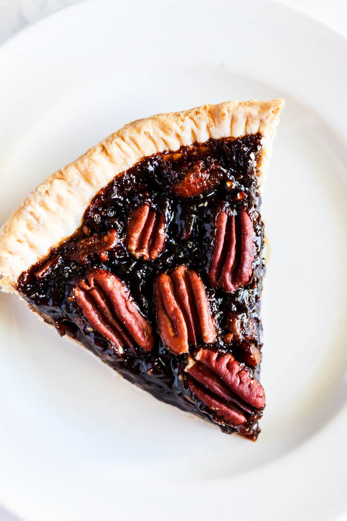 A slice of this Vegan Pecan Pie is all you need this holiday season! The sweet, gooey pecan filling tops a flaky crust that is irresistible. A must-have!