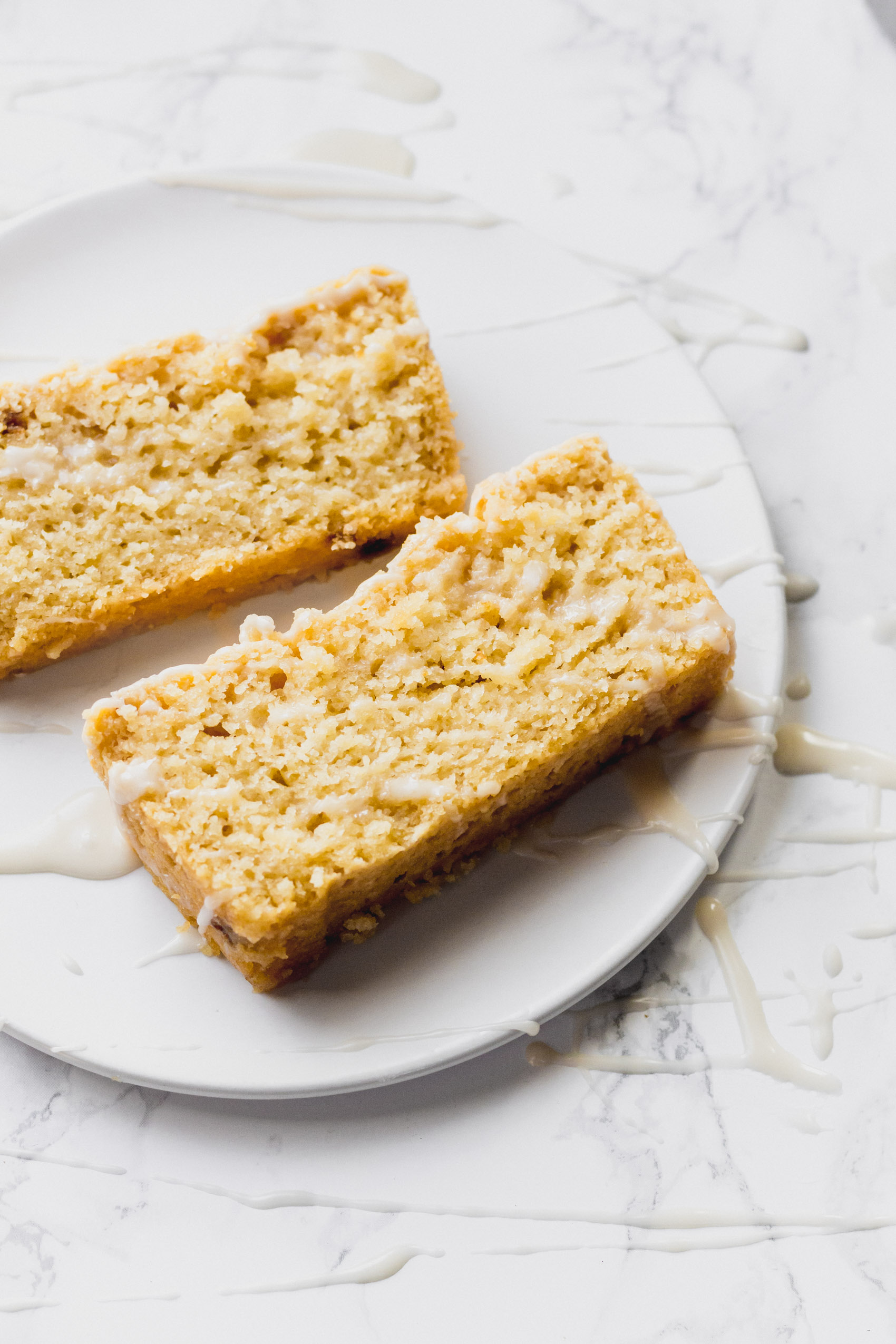 two slices of lemon bread served on a white plate