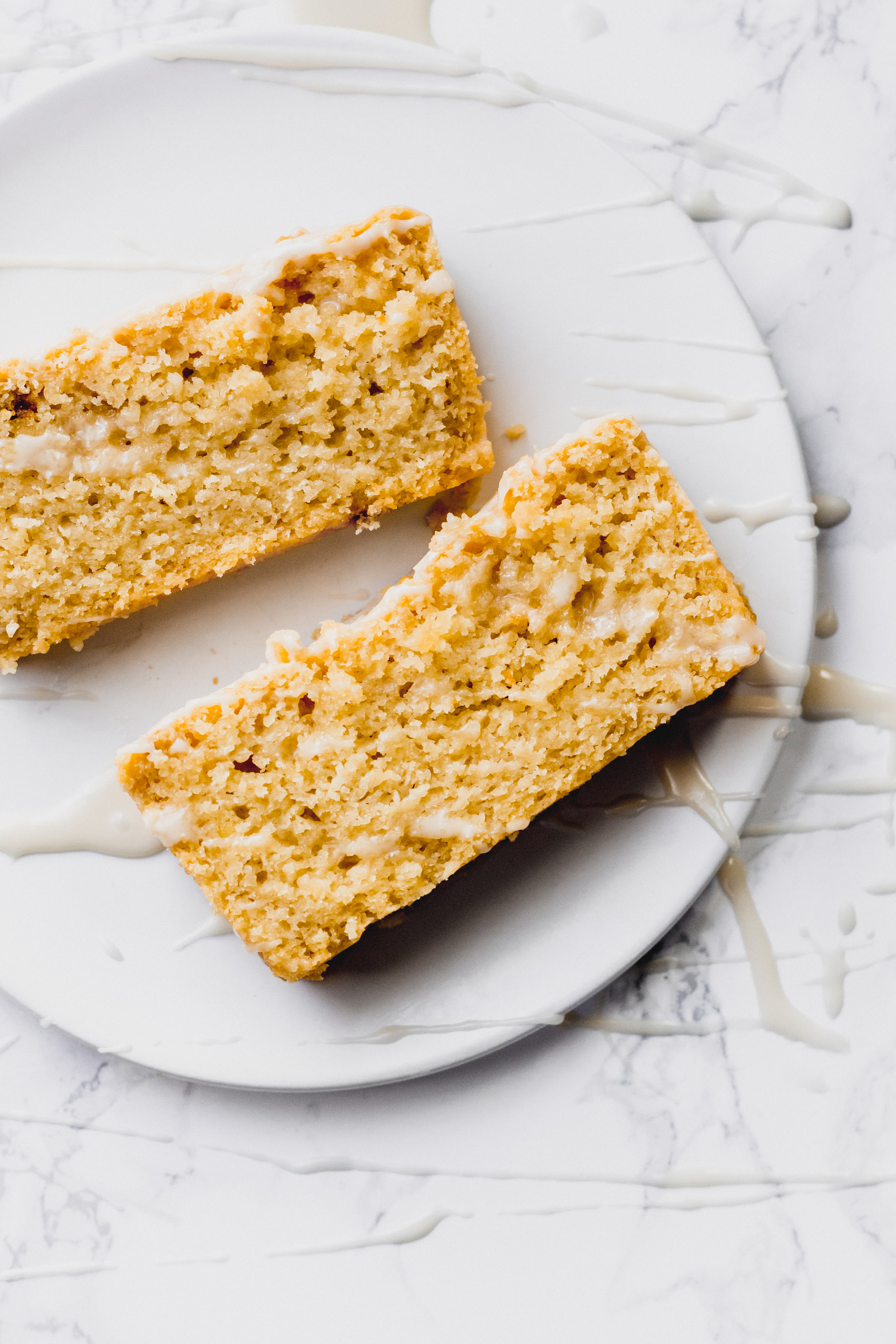 two slices of vegan lemon bread served on a white dish