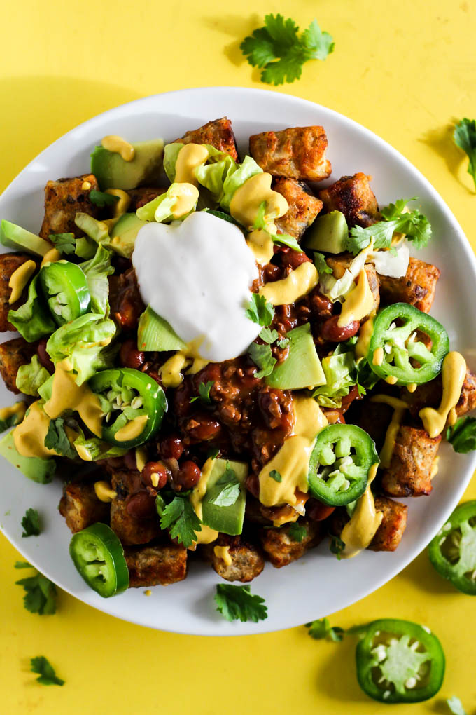 Serve up a plate of these Loaded Vegan Chili Cheese Tots as a delicious appetizer perfect for sharing! Full of bean chili, dairy-free cheese, and veggies.