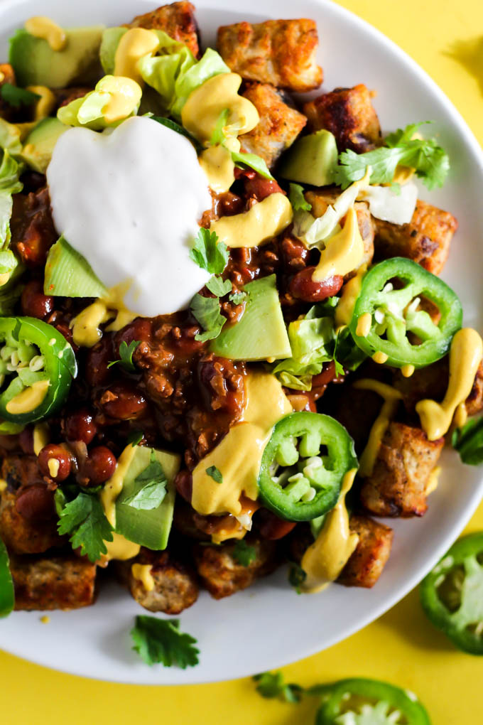 Serve up a plate of these Loaded Vegan Chili Cheese Tots as a delicious appetizer perfect for sharing! Full of bean chili, dairy-free cheese, and veggies.