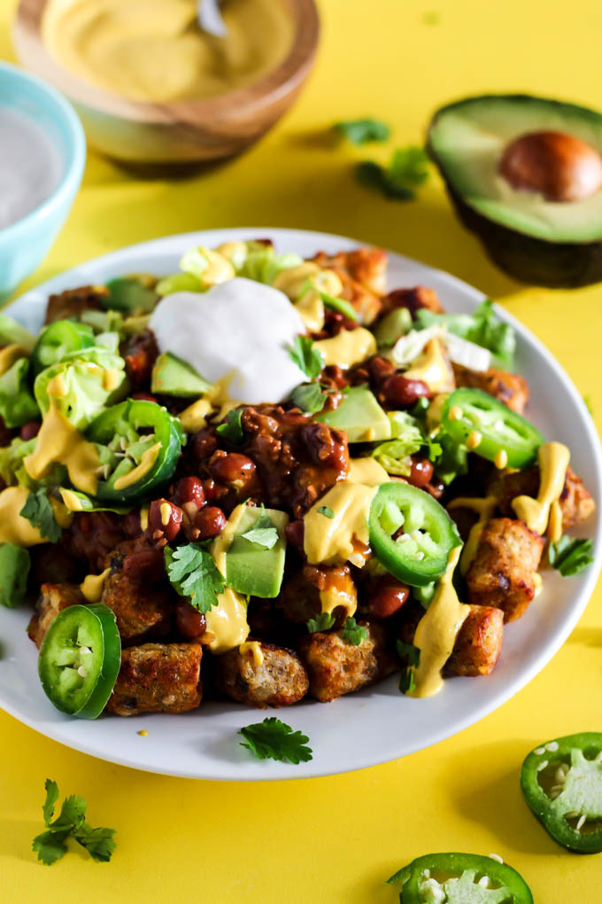 Serve up a plate of these Loaded Vegan Chili Cheese Tots as a delicious appetizer perfect for sharing! Full of bean chili, dairy-free cheese, and veggies.
