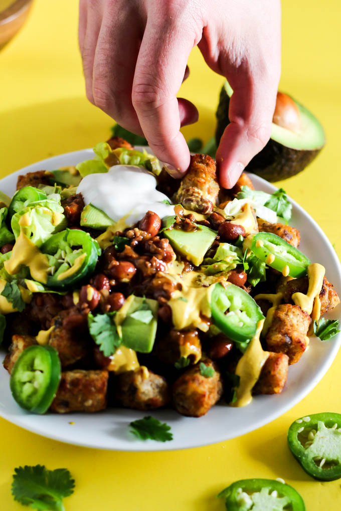 Serve up a plate of these Loaded Vegan Chili Cheese Tots as a delicious appetizer perfect for sharing! Full of bean chili, dairy-free cheese, and veggies.
