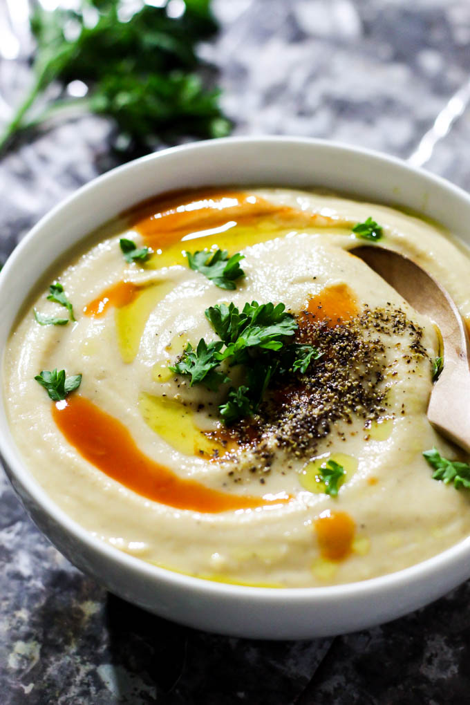 This Roasted Garlic Cauliflower Soup is a cozy bowl of wholesome ingredients that’s perfect as a side dish or main meal! Vegan, gluten-free, done in 1 hour.