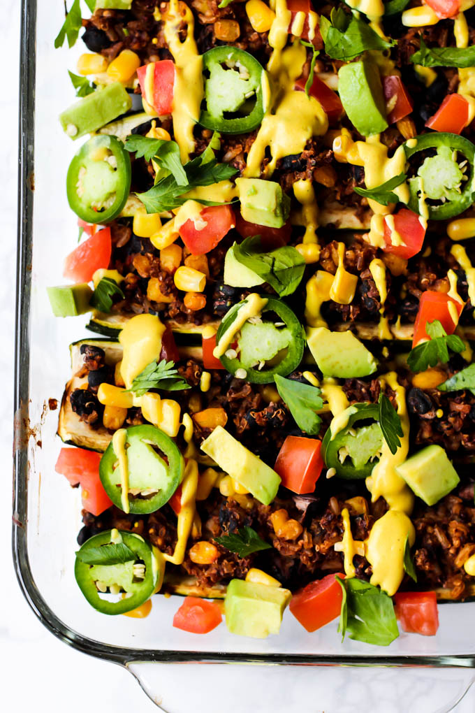 These easy Mexican Stuffed Zucchini make a balanced dinner with whole grains, vegetables & plant protein! Top with avocado & cashew cheese for more flavor.