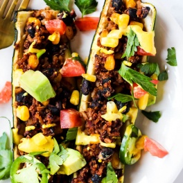 These easy Mexican Stuffed Zucchini make a balanced dinner with whole grains, vegetables & plant protein! Top with avocado & cashew cheese for more flavor.