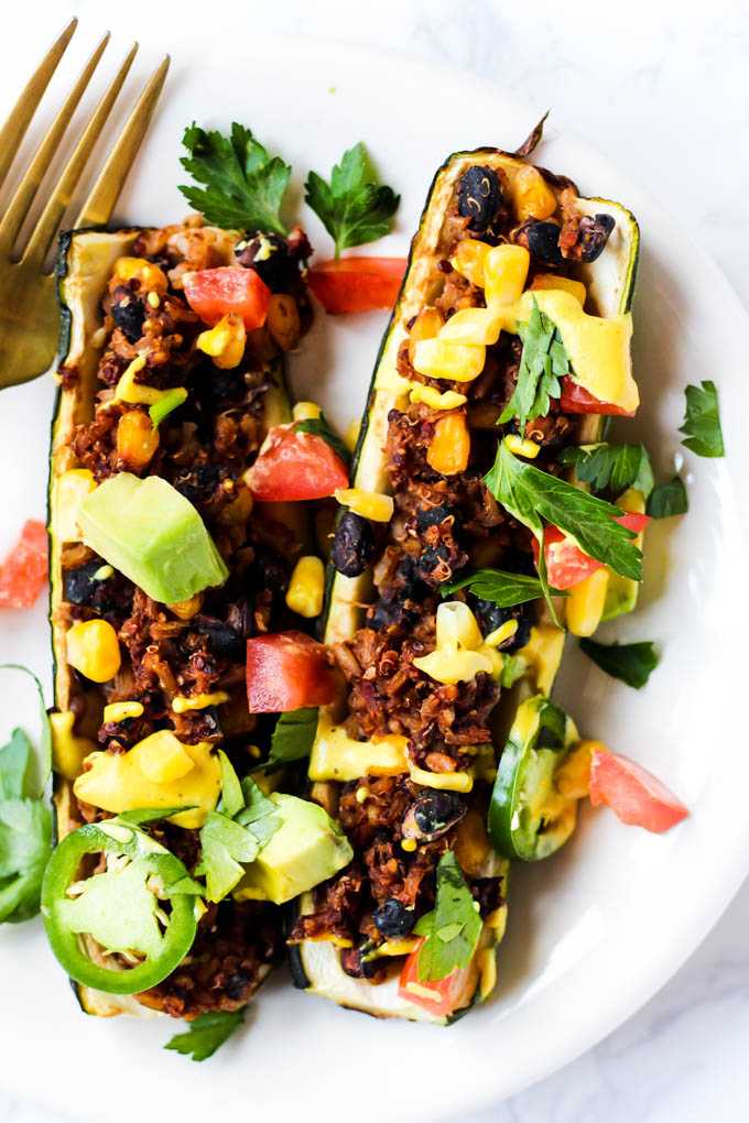 These easy Mexican Stuffed Zucchini make a balanced dinner with whole grains, vegetables & plant protein! Top with avocado & cashew cheese for more flavor.