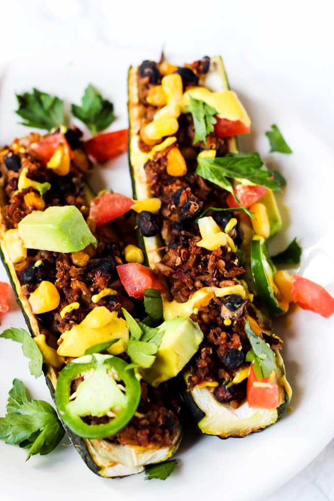 These easy Mexican Stuffed Zucchini make a balanced dinner with whole grains, vegetables & plant protein! Top with avocado & cashew cheese for more flavor.