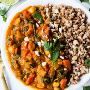 a peanut stew served with a grain blend, lime and cilantro