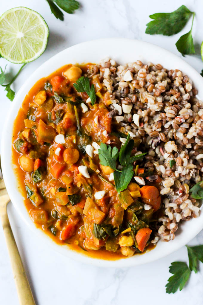 a peanut stew served with a grain blend, lime and cilantro