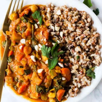 a chickpea peanut stew served with a grain blend and topped with cilantro