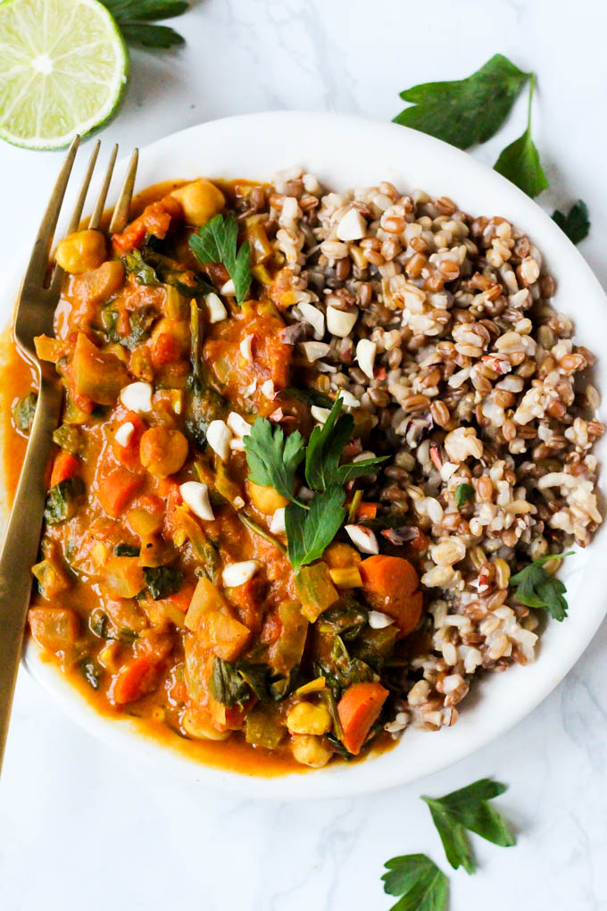 a chickpea peanut stew served with a grain blend and topped with cilantro