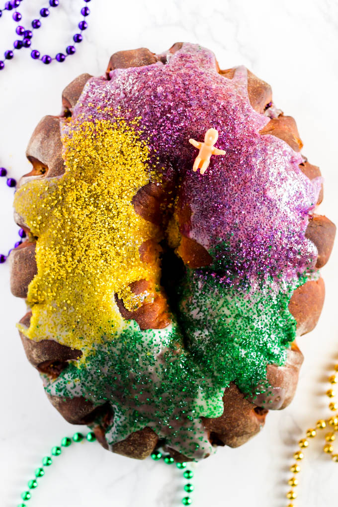 a king cake with a plastic baby sitting on top