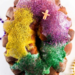 a king cake with a small plastic baby sitting on top