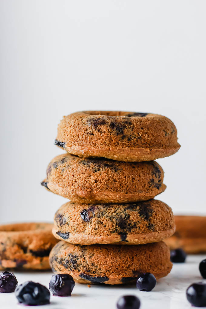 A stack of four vegan gluten free blueberry donuts