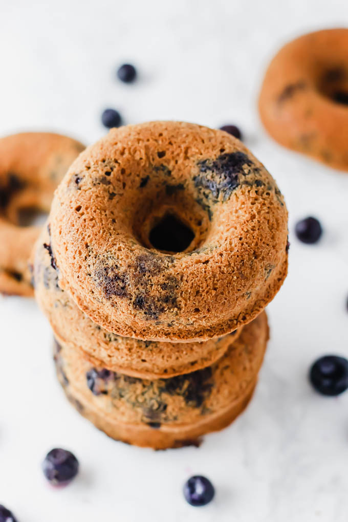 An overhead shot of a stack of vegan blueberry donuts