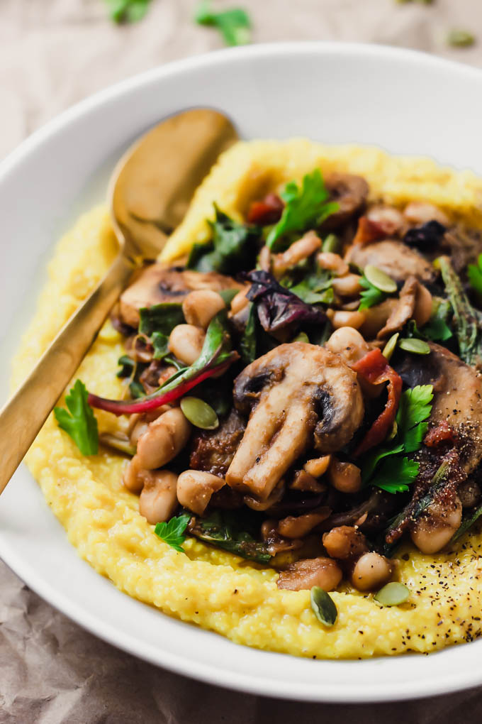 a bowl of polenta with mushrooms and beans