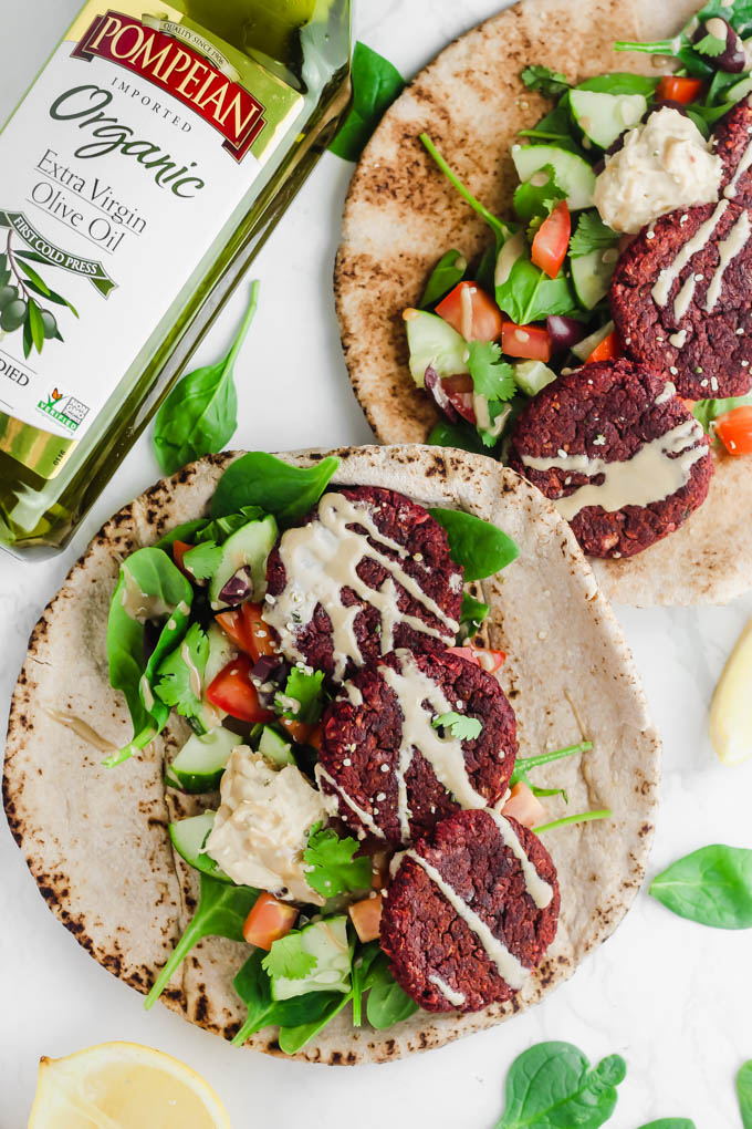 two beet falafel pitas topped with tahini