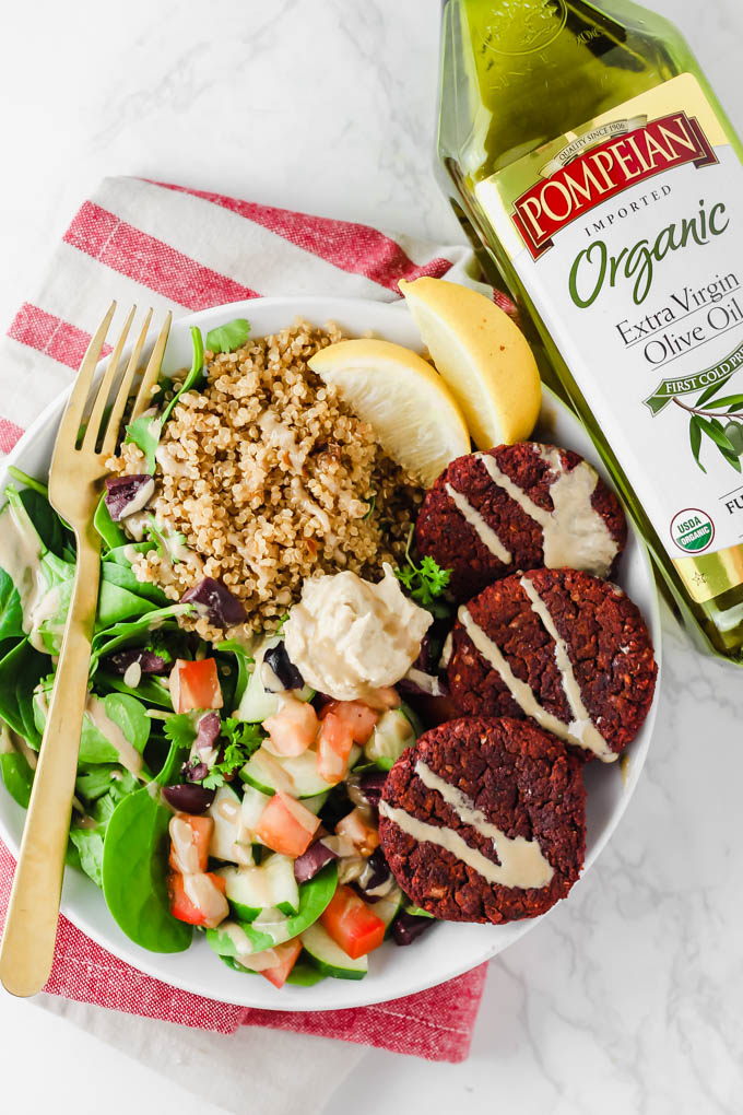 a falafel bowl served next to a bottle of olive oil