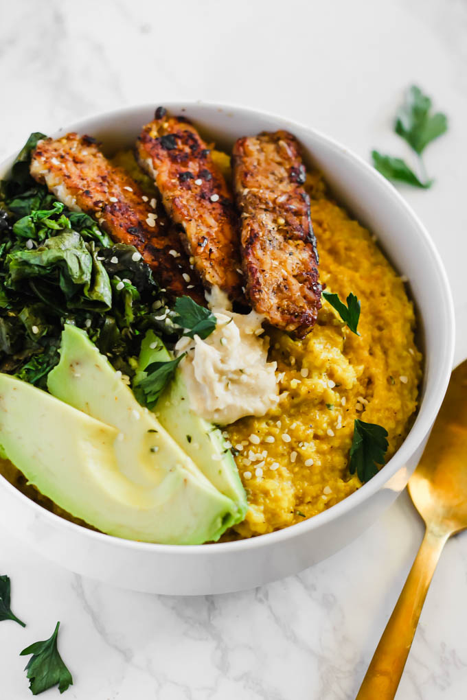 Enjoy these Savory Turmeric Oat Bowls for breakfast, lunch, or dinner as a hearty, nourishing meal! The turmeric adds an anti-inflammatory boost, and the tempeh bacon will satisfy your tastebuds.