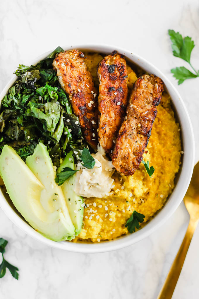 Enjoy these Savory Turmeric Oat Bowls for breakfast, lunch, or dinner as a hearty, nourishing meal! The turmeric adds an anti-inflammatory boost, and the tempeh bacon will satisfy your tastebuds.