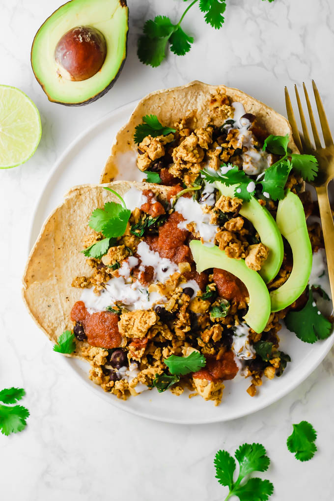 This protein-packed Vegan No-Huevos Rancheros dish is the perfect savory meal to serve for brunch, lunch, or dinner! Top with zesty ranchero sauce and tangy dairy-free sour cream for the ultimate plate.