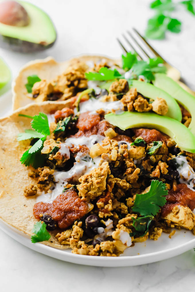 This protein-packed Vegan No-Huevos Rancheros dish is the perfect savory meal to serve for brunch, lunch, or dinner! Top with zesty ranchero sauce and tangy dairy-free sour cream for the ultimate plate.