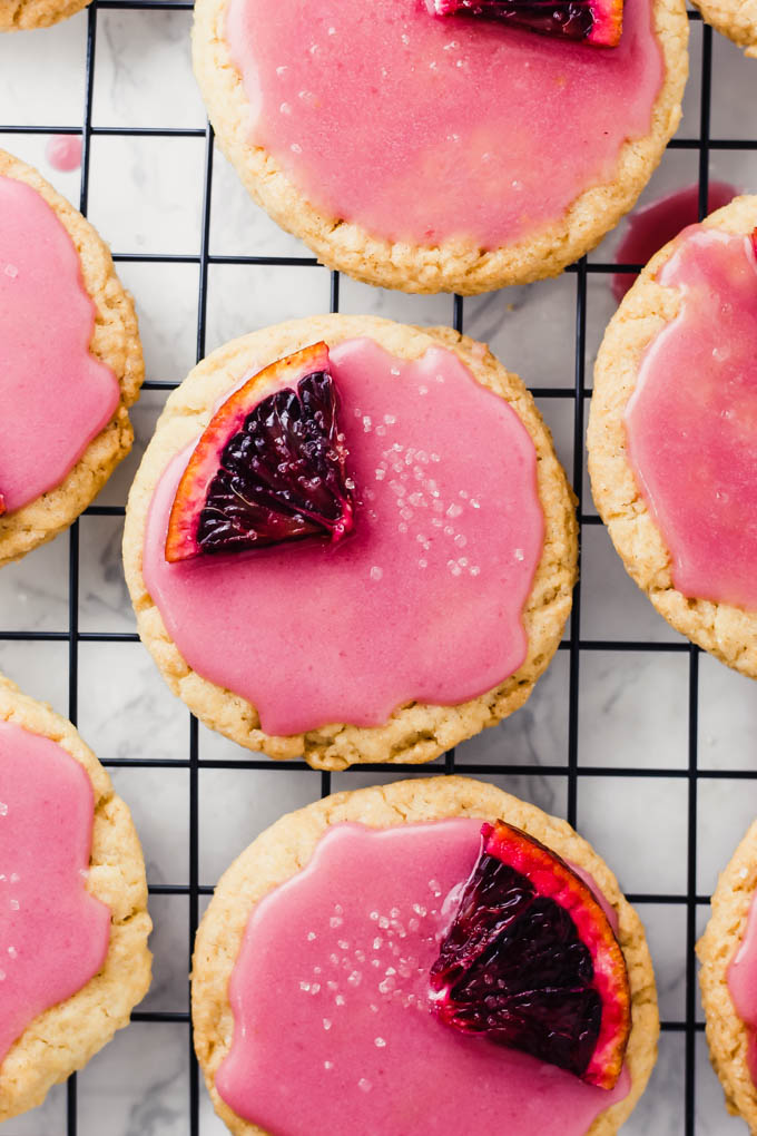 a batch of blood orange sugar cookies rest on a cooling rack