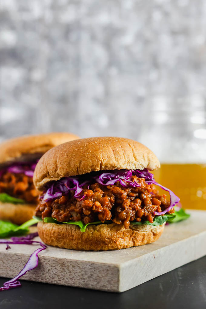 a lentil bbq sandwich topped with purple cabbage and lettuce