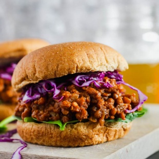 a vegan sloppy joe topped with purple cabbage and lettuce