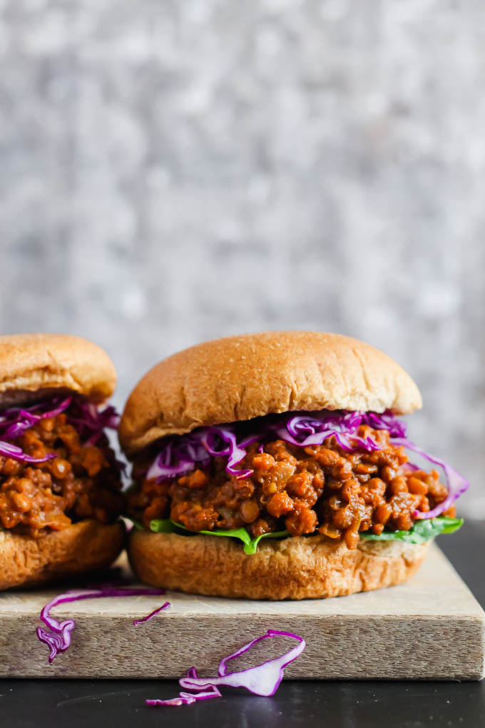 two vegan bbq lentil sandwiches served on a cutting board