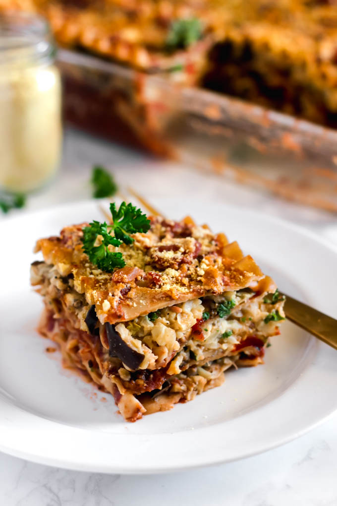 This Roasted Vegetable Lasagna is the ultimate plant-based comfort food! It's full of nutritious vegetables, whole grain lasagna, and protein-packed beans. Vegan & freezer-friendly!