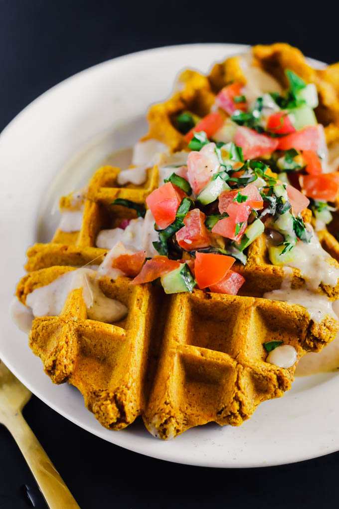 These Vegan Falafel Waffles are studded with traditional Middle Eastern spices and incredibly fluffy thanks to a secret ingredient! Drizzle on tahini sauce and enjoy for a wholesome breakfast, lunch or dinner.