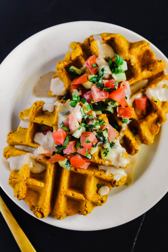 These Vegan Falafel Waffles are studded with traditional Middle Eastern spices and incredibly fluffy thanks to a secret ingredient! Drizzle on tahini sauce and enjoy for a wholesome breakfast, lunch or dinner.