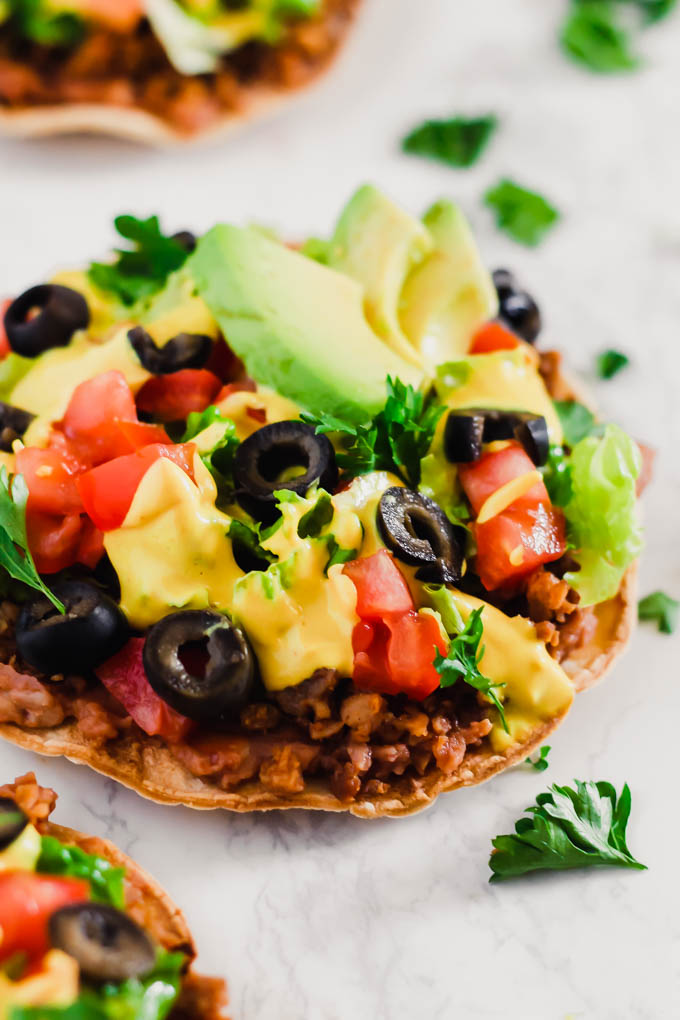 These Vegan Seven Layer Tostadas are loaded with all of your favorite taco toppings like beans, cashew cheese and avocado! A healthy 30-minute meal great for busy weeknights or for serving a crowd.