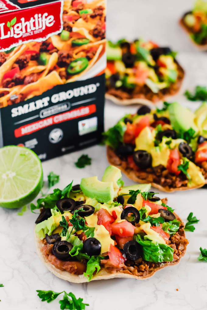 These Vegan Seven Layer Tostadas are loaded with all of your favorite taco toppings like beans, cashew cheese and avocado! A healthy 30-minute meal great for busy weeknights or for serving a crowd.