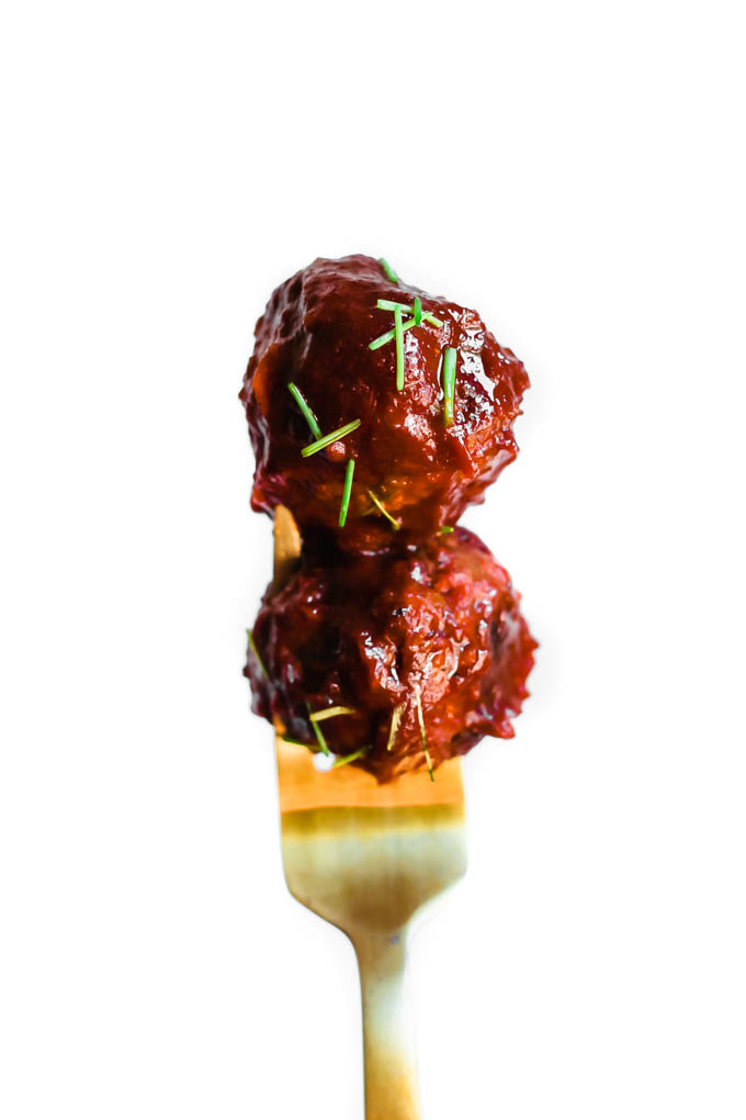 a fork holding two bbq meatballs