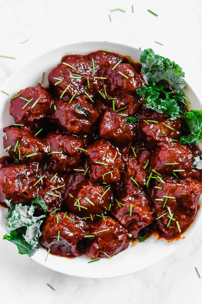 a bowl of meatballs mixed with barbecue sauce
