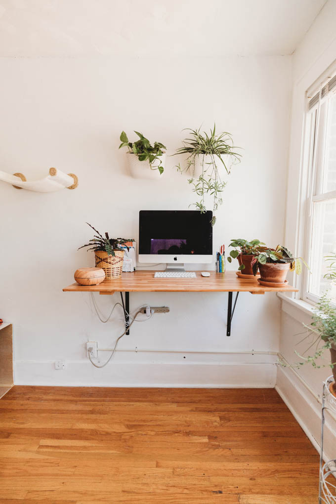 Check out my renter-friendly, affordable apartment makeover—from basic and beige to a bright, boho, modern space full of plants and DIYs! 