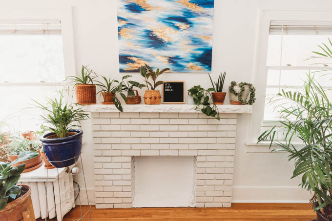 Check out my renter-friendly, affordable apartment makeover—from basic and beige to a bright, boho, modern space full of plants and DIYs! 