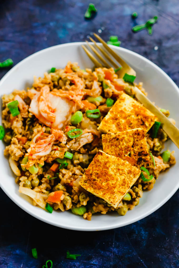 A close up shot of a bowl of vegan kimchi fried rice