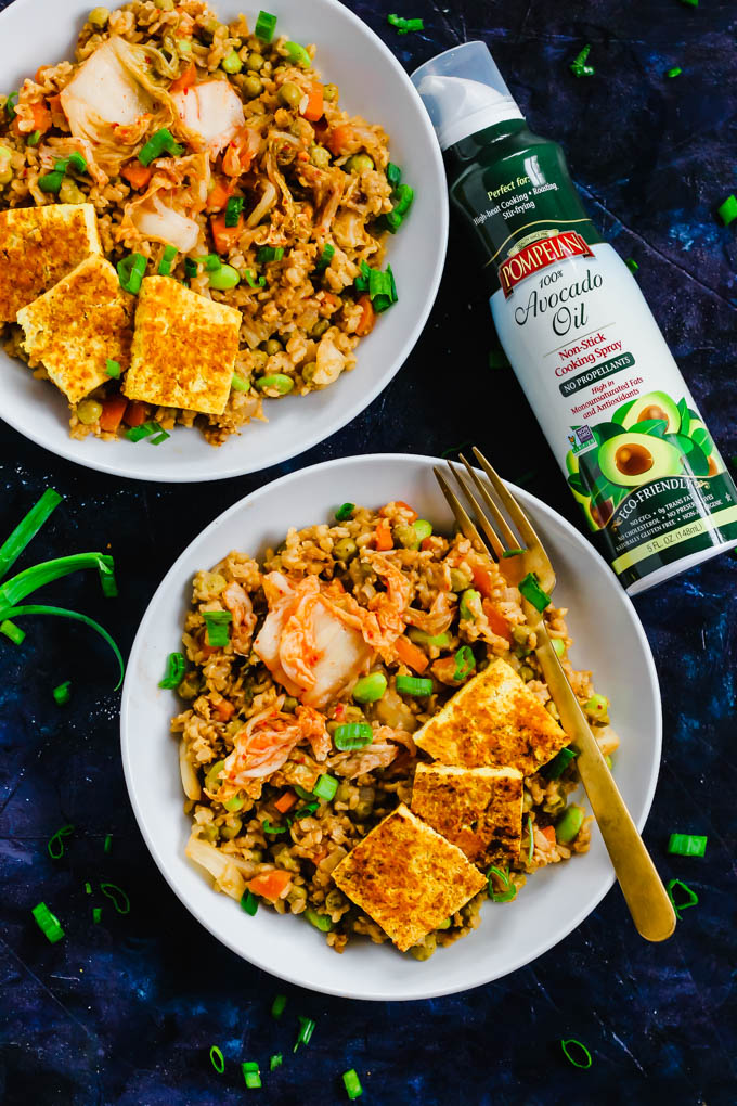 Two bowls of vegan kimchi fried rice alongside a can of avocado oil cooking spray