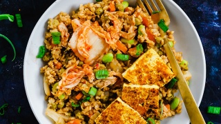 A bowl of vegan kimchi fried rice topped with green onions