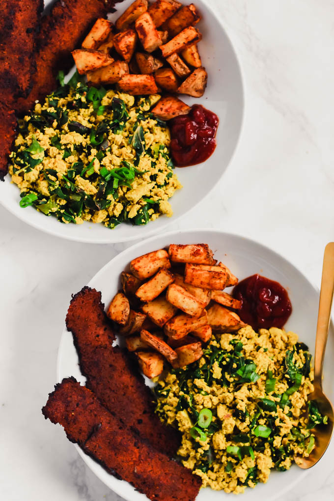 This loaded Vegan Breakfast Plate is the ultimate weekend brunch! It features eggy tofu scramble, veggie bacon, and crispy roasted potatoes.